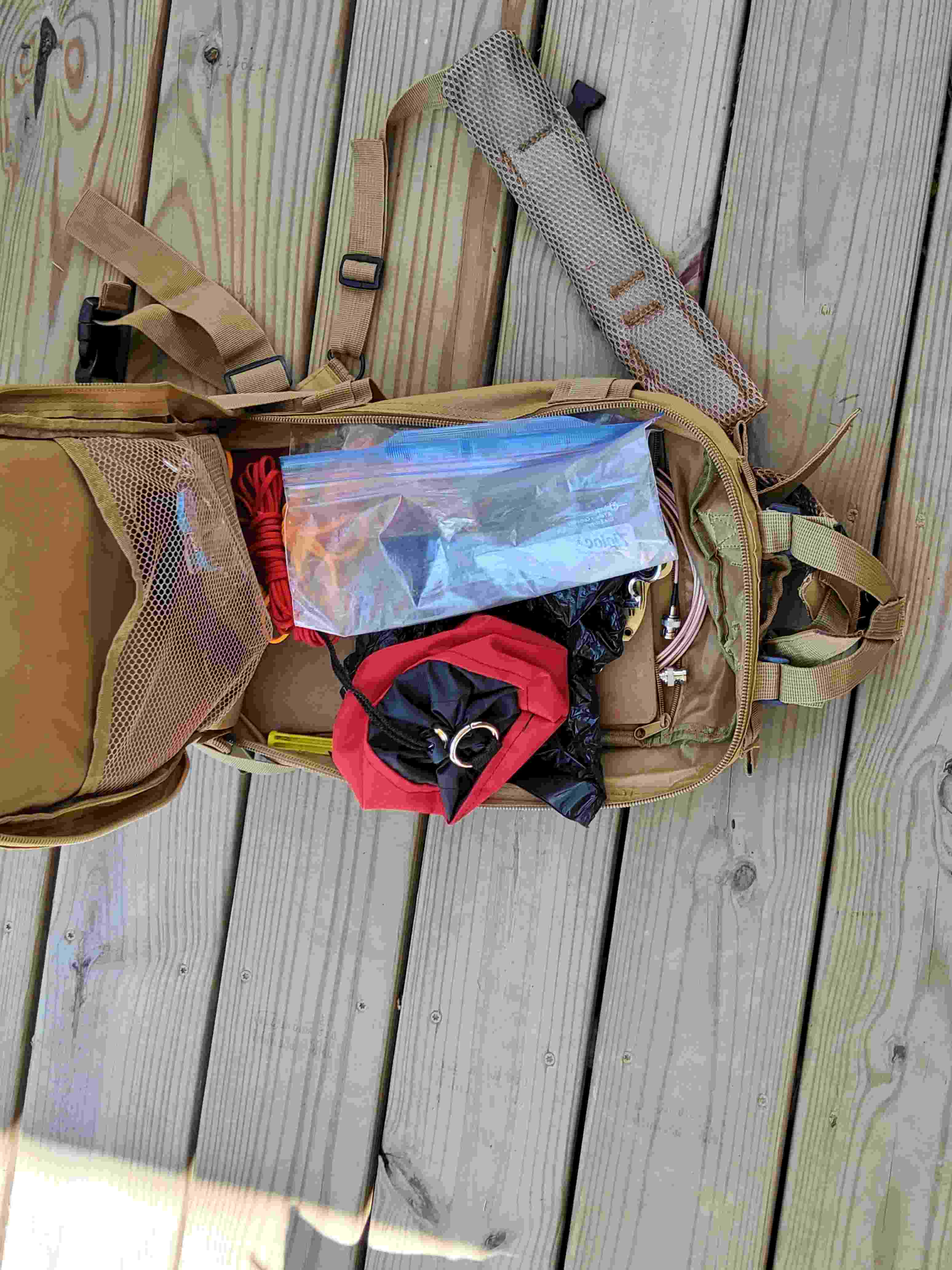 Large pocket of tactical daypack with clipboard, throw line bag, antenna, etc.